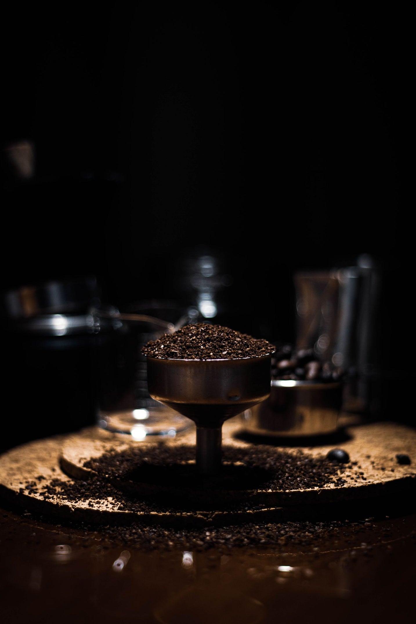 Coffee grinder with leftover grounds on a dark wooden surface