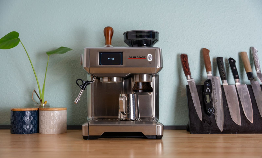 Espresso machine settled into a wooden home kitchen counter