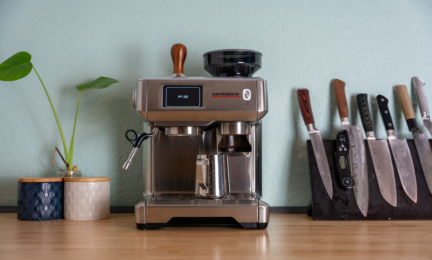 Espresso machine settled into a wooden home kitchen counter