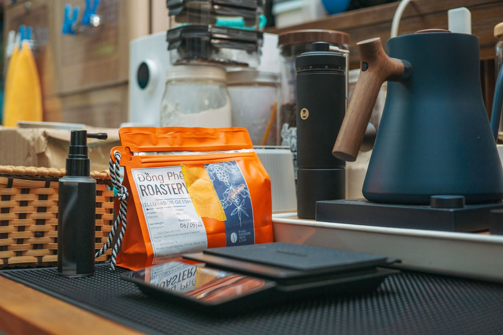 Fresh roastery coffee bag beside brewing gear ready for dialing in