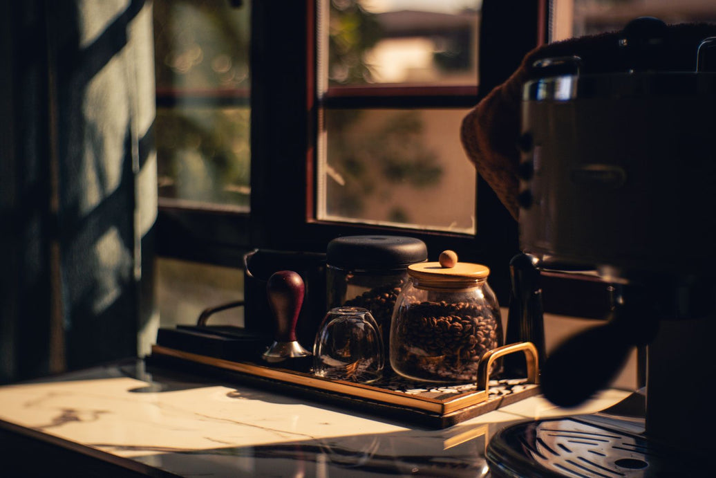 Complete home espresso corner with machine, grinder, and beans in sunlight