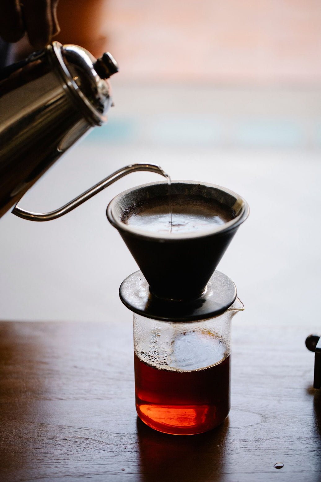 Moody close-up of a manual pour over brew in progress